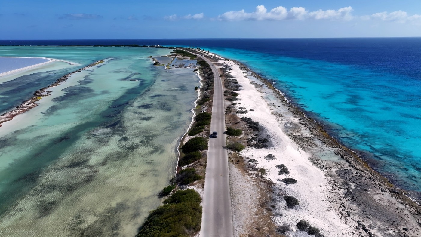 A coastal road between shallow lagoons and turquoise sea in Bonaire