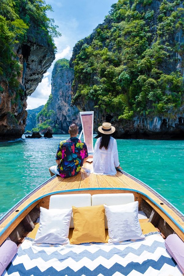 Couple travelling by longtail boat between Thailand’s islands